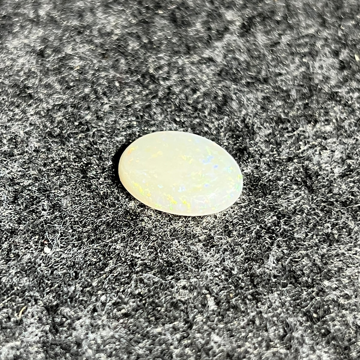 Natural Australian white opal, 4.89ct oval cabochon 16x12mm, with soft pastel play-of-colour