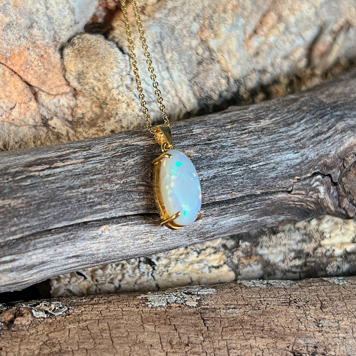 Oval white opal pendant, 14.5 x 7.9mm Australian white opal claw set in 18kt yellow gold