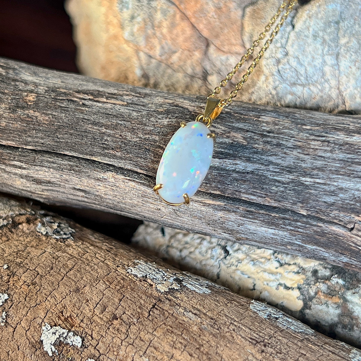 Solid Australian white opal pendant, 2.3ct oval stone with blue and green pinfire in 18kt yellow gold