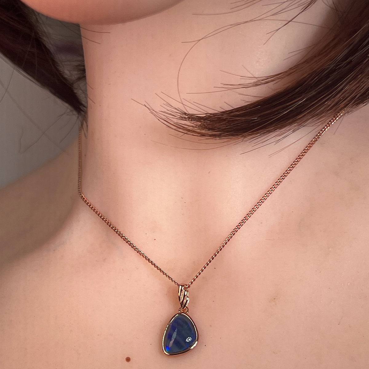 Worn Australian opal triplet pendant in rose gold-plated silver, red, green and blue, 11 x 8mm
