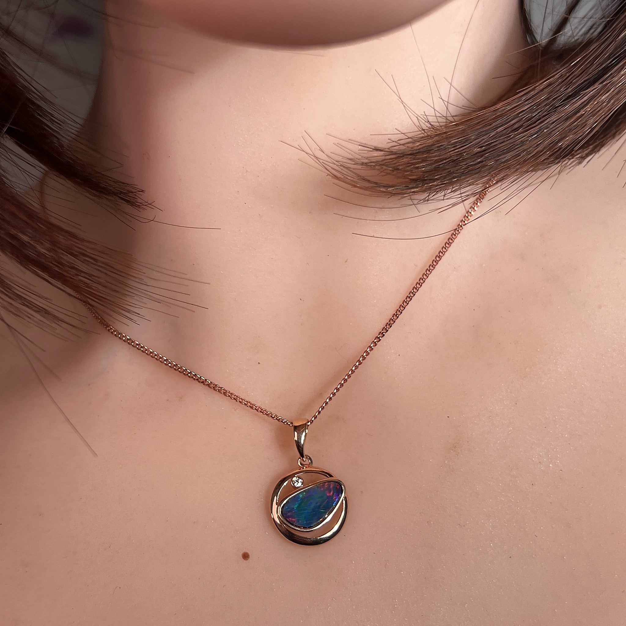 12 x 11mm freeform Australian opal doublet pendant worn at the neck, rose gold-plated silver
