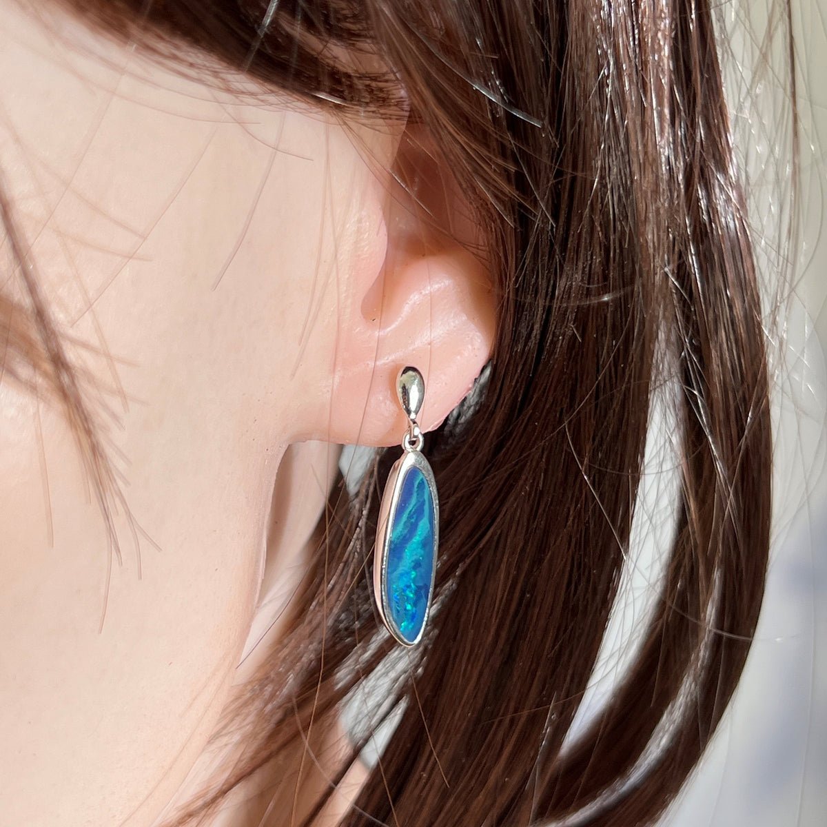 Australian opal doublet earrings worn on the ear, sterling silver, 24 x 8mm freeform stones