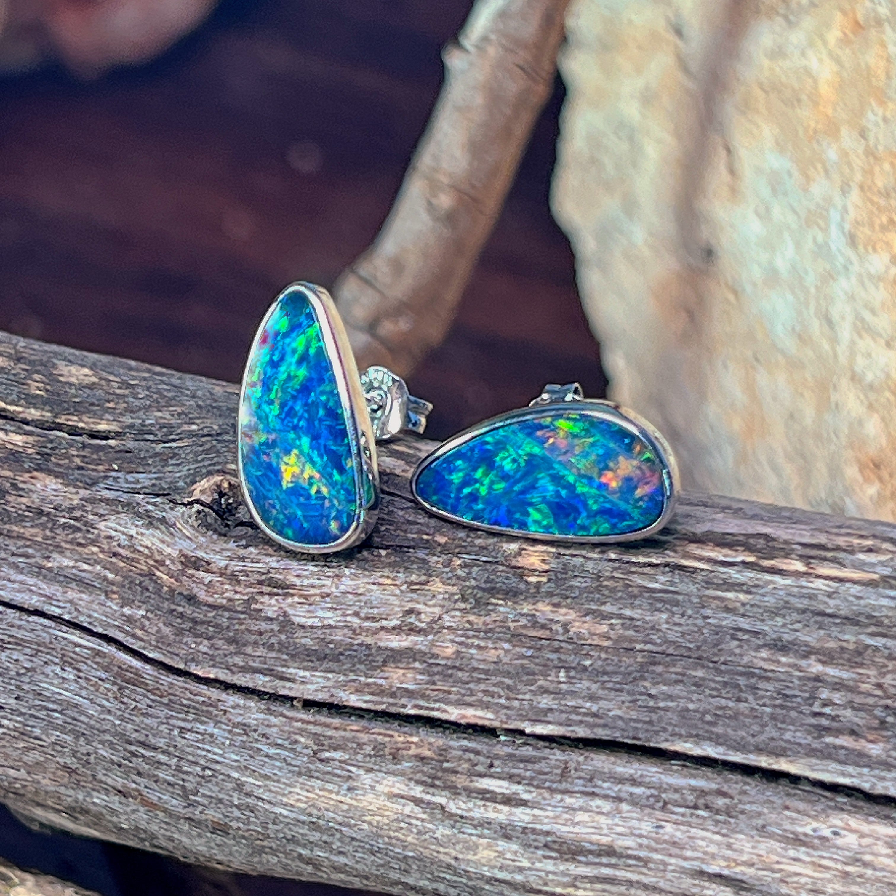 Blue-green opal doublet stud earrings in silver, showing the bezel setting and posts