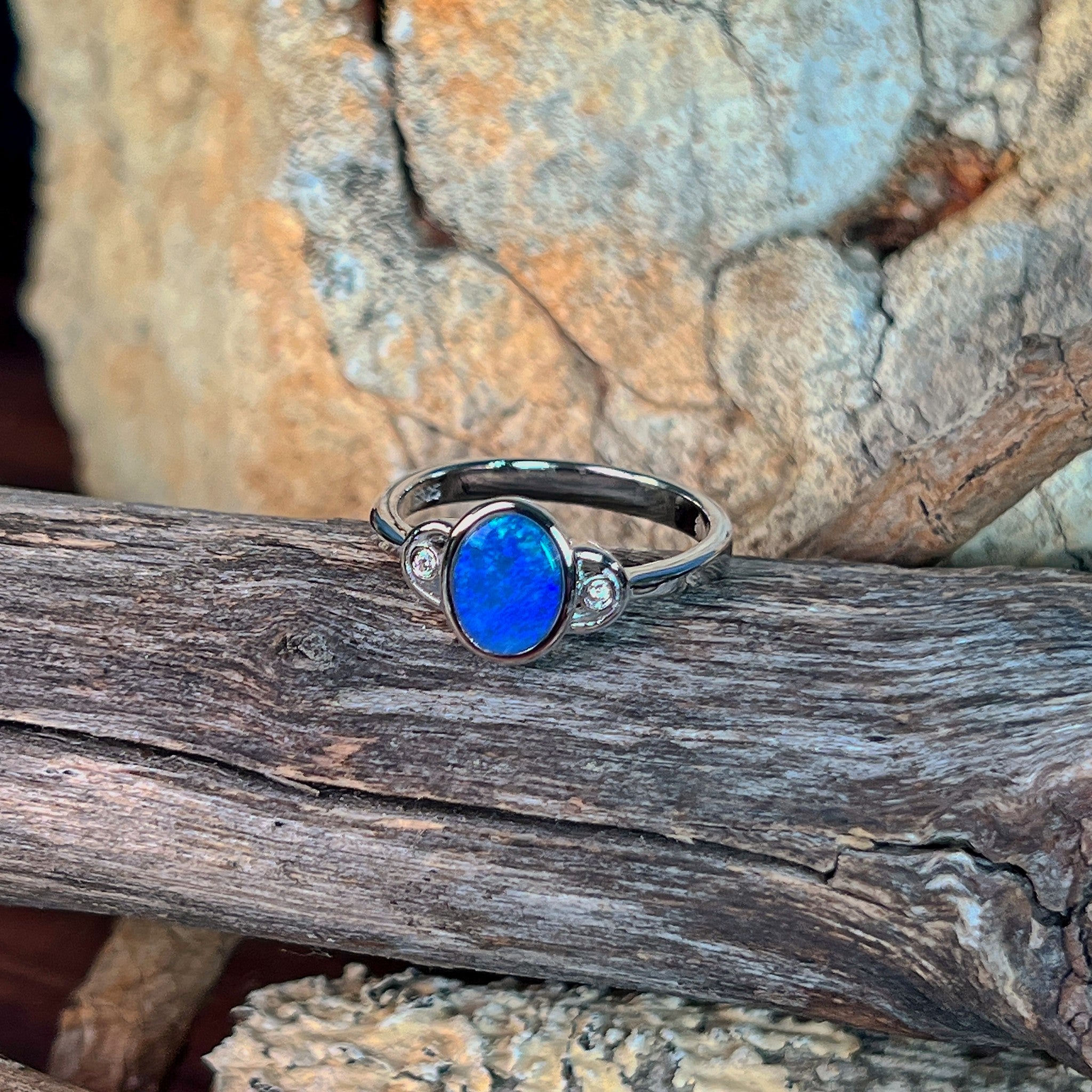 Close view of the blue and green play of colour in the oval opal doublet