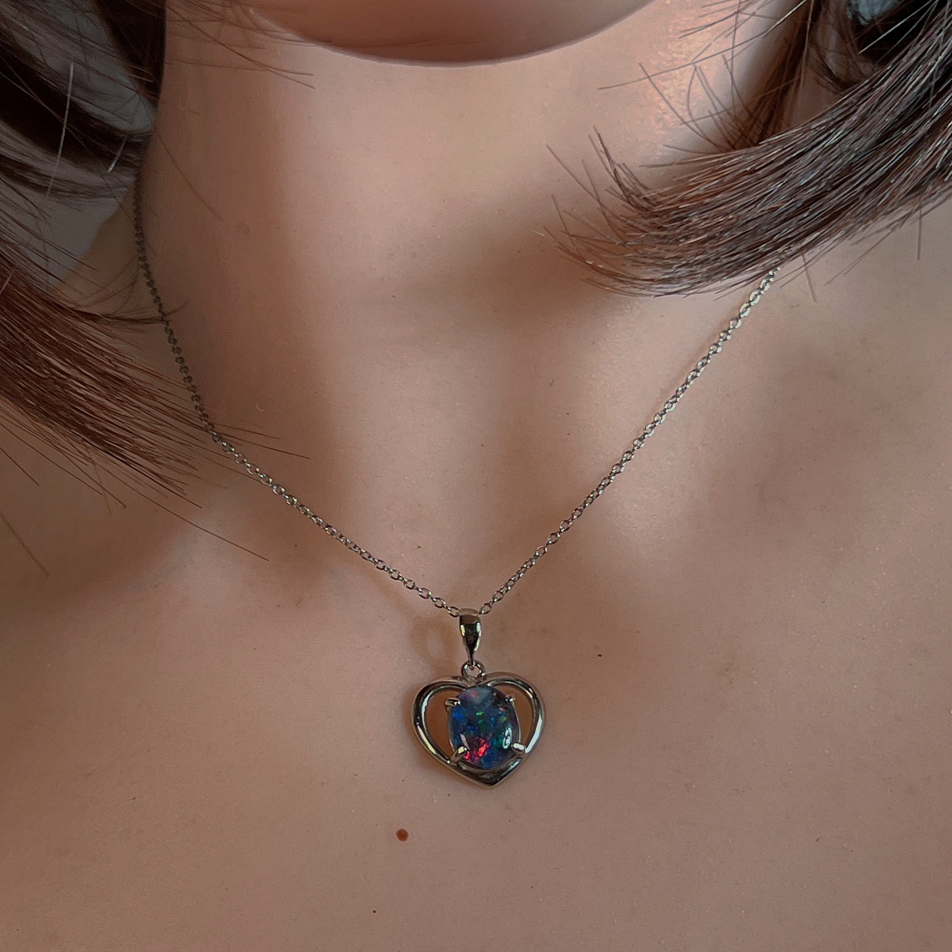 Sterling silver heart opal triplet pendant worn at the neck on a fine chain