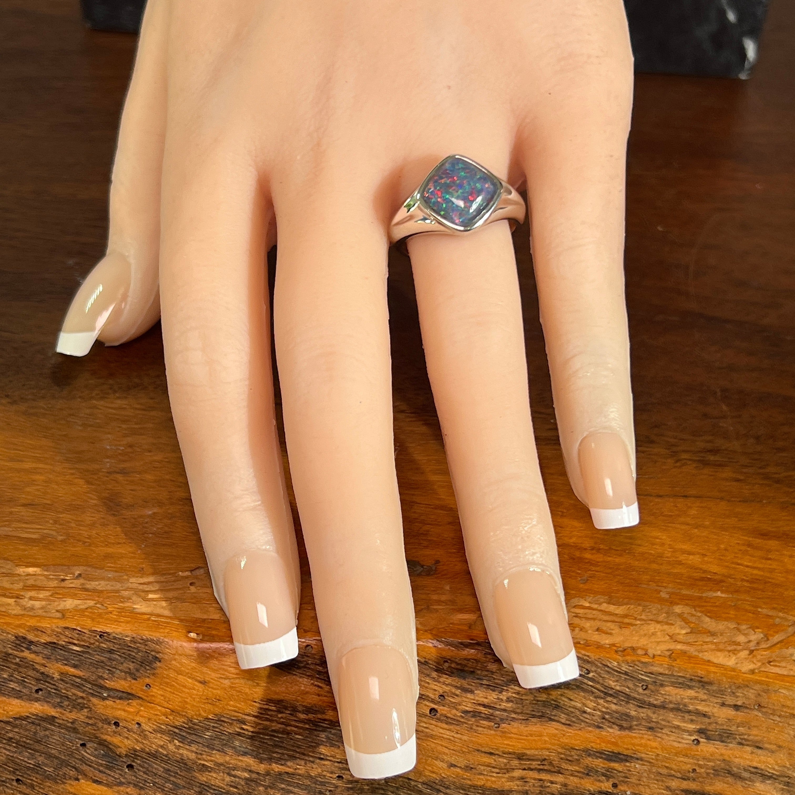 Australian opal triplet ring in sterling silver worn, cushion-shaped stone, size US 8