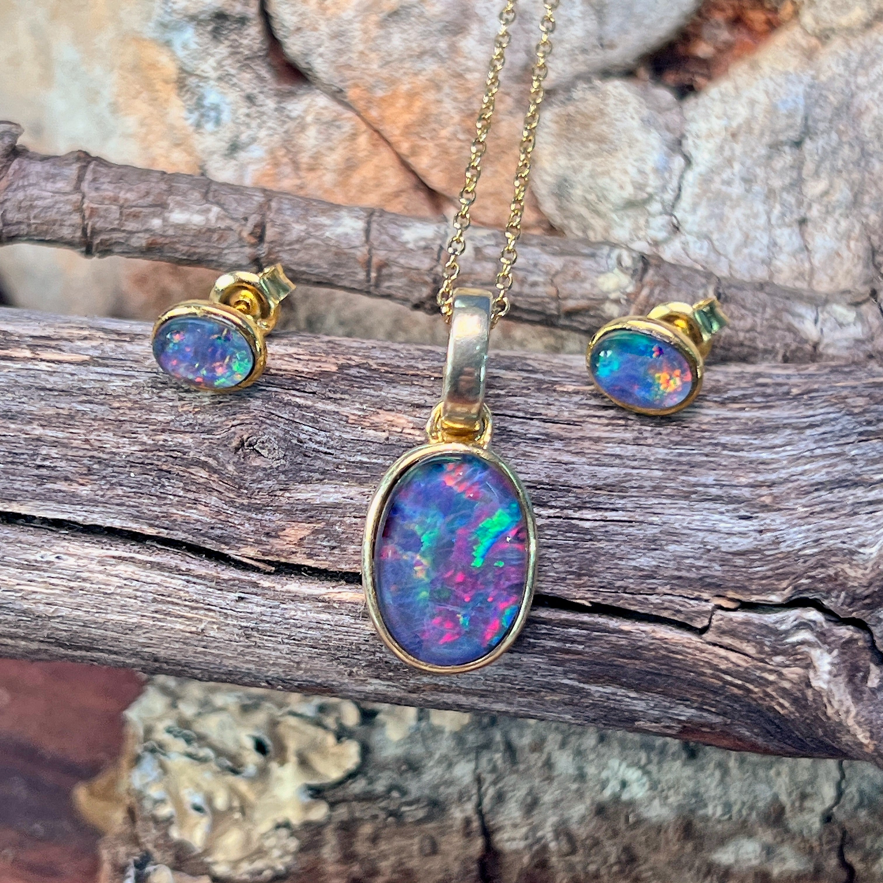 Bezel-set oval opal triplet pendant showing red, pink and green play-of-colour