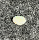 Natural Australian white opal, 5.56ct oval cabochon 16x12mm, showing green play-of-colour