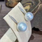 South Sea pearl drop earrings angled to show the pave diamond bar above each 15-16mm pearl