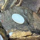 16x12mm oval white opal showing delicate pale blue play-of-colour