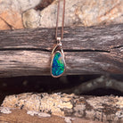 green, red and blue play-of-colour in a 12 x 6.5mm freeform Australian opal doublet pendant