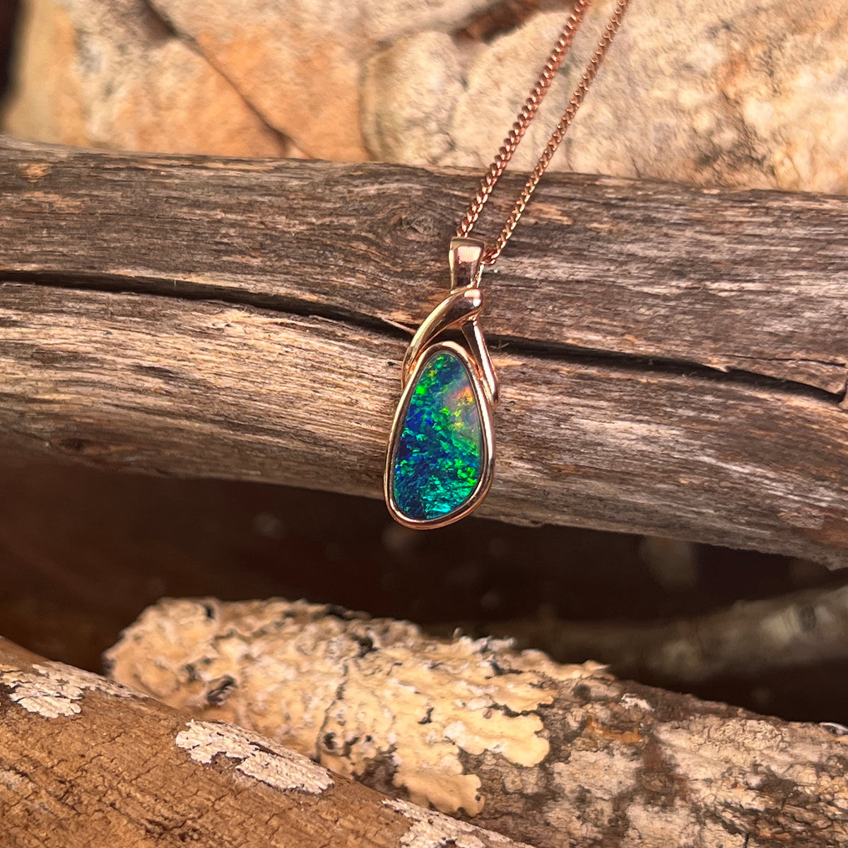 Australian opal doublet pendant, rose gold-plated silver, 12 x 6.5mm stone showing green, red and blue