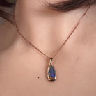 Australian opal doublet pendant worn at the neck, green, orange and violet play-of-colour
