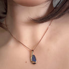 Worn Australian opal doublet pendant in rose gold-plated silver, green, orange and violet, 12 x 6.5mm