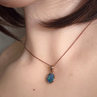 freeform Australian opal triplet pendant in rose gold-plated silver, worn at the neck