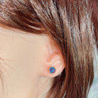 6mm round Australian opal triplet earrings worn on the ear, rose gold-plated silver