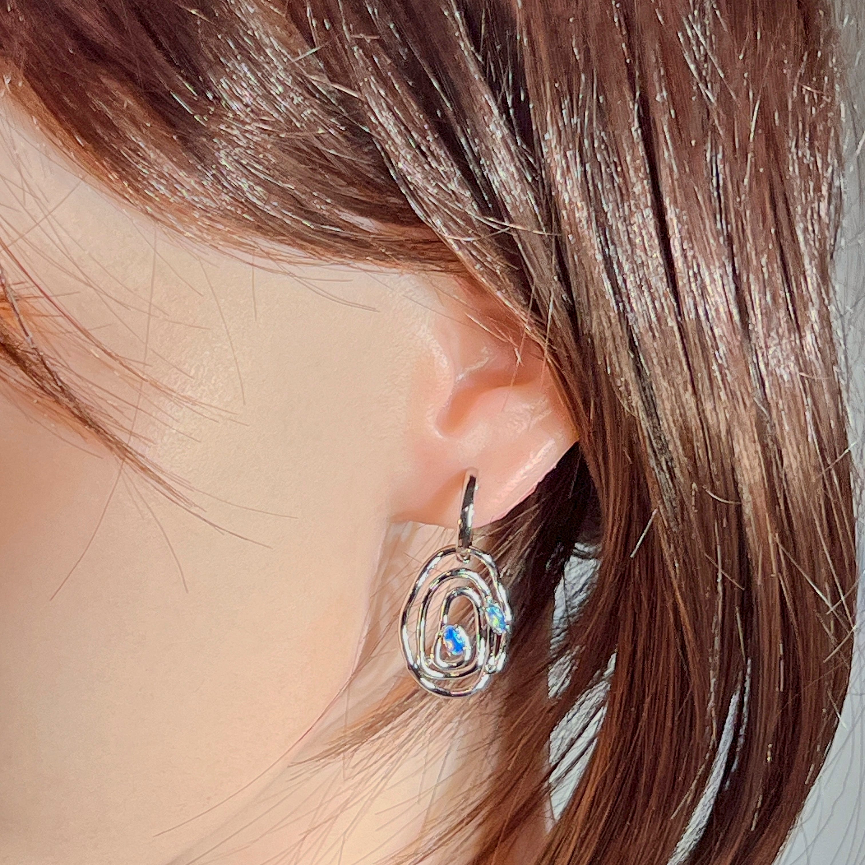 Worn view of the sterling silver Australian opal circle earrings