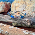 Side profile of the sterling silver wave cut-out bangle and its freeform opal doublet