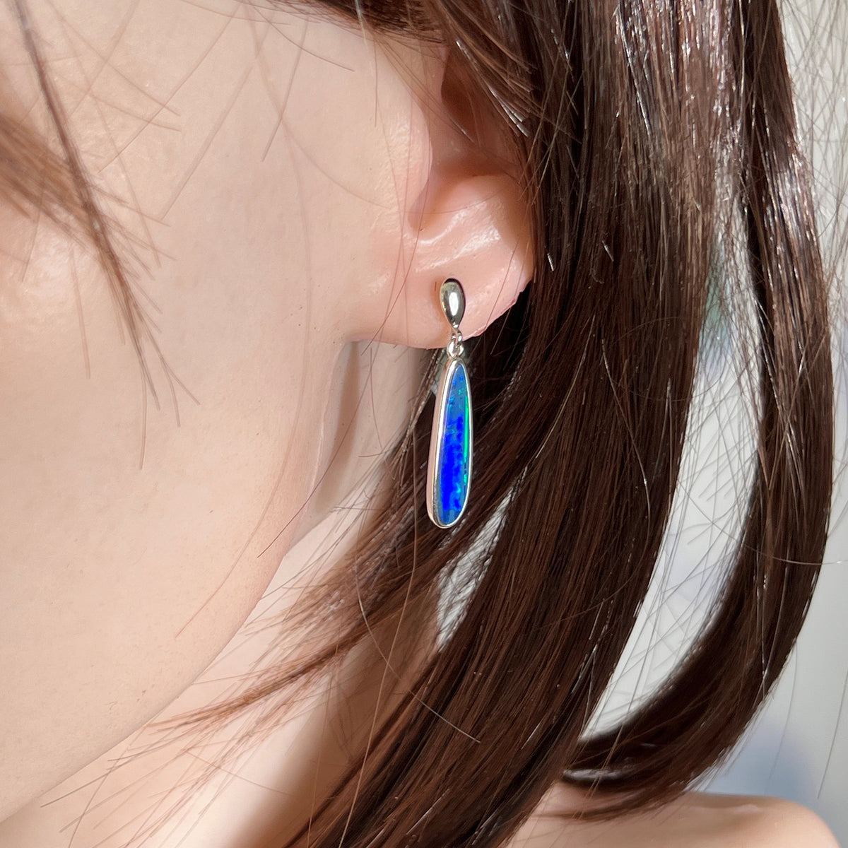 Worn Australian opal doublet earrings in sterling silver, green and blue, 23 x 6mm