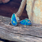 Blue-green opal doublet stud earrings in silver, showing the bezel setting and posts