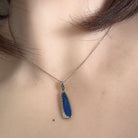 Australian opal doublet pendant worn at the neck, sterling silver, 20 x 6mm oval stone