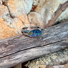 Close view of the yellow, red and green play of colour in the oval opal doublet