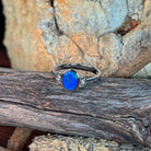 Close view of the blue and green play of colour in the oval opal doublet