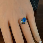 Sterling silver opal doublet ring worn on the hand, side view of the setting