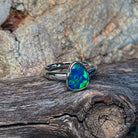 Pear opal doublet ring in silver viewed from the side, showing the slim band
