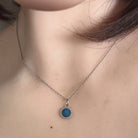 round Australian opal doublet pendant in sterling silver, worn at the neck