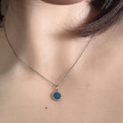 7mm round Australian opal doublet pendant worn at the neck, sterling silver