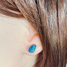 Worn Australian opal doublet earrings in sterling silver, red, blue and green, 10 x 7mm