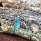 brown, green and blue play-of-colour in an 18 x 7mm freeform Australian boulder opal pendant