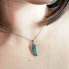 Australian boulder opal pendant worn at the neck, brown, green and blue play-of-colour