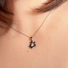 Worn Australian crystal opal pendant in sterling silver, red, green, blue and pink, 7 x 5mm