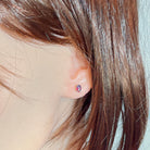 10x8mm claw-set opal triplet earring worn on the ear beneath loose hair