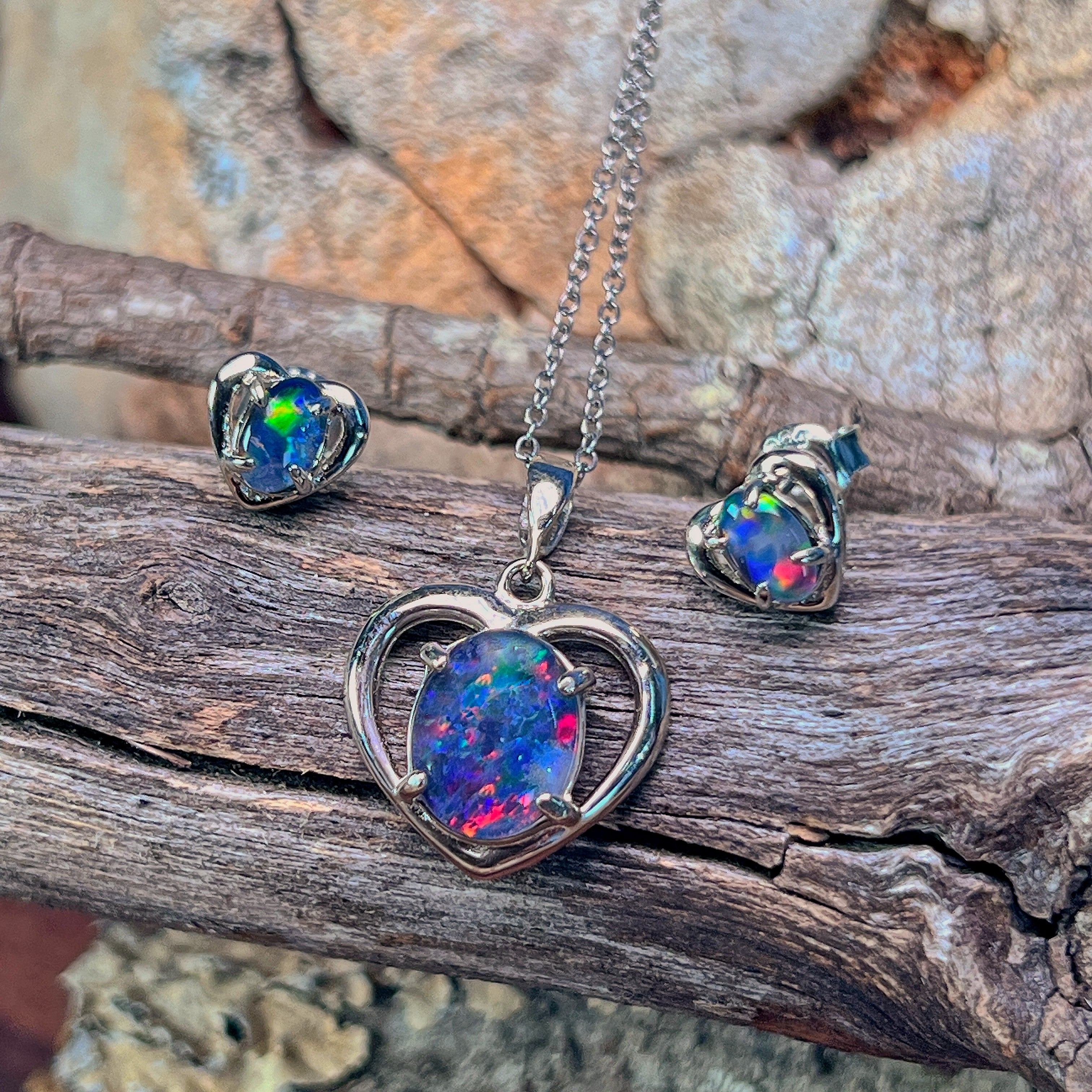 Heart-shaped opal triplet pendant in sterling silver showing green and red fire