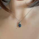 Sterling silver opal triplet pendant worn at the neck on a fine chain