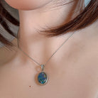 Sterling silver opal triplet pendant worn on a fine chain at the neckline