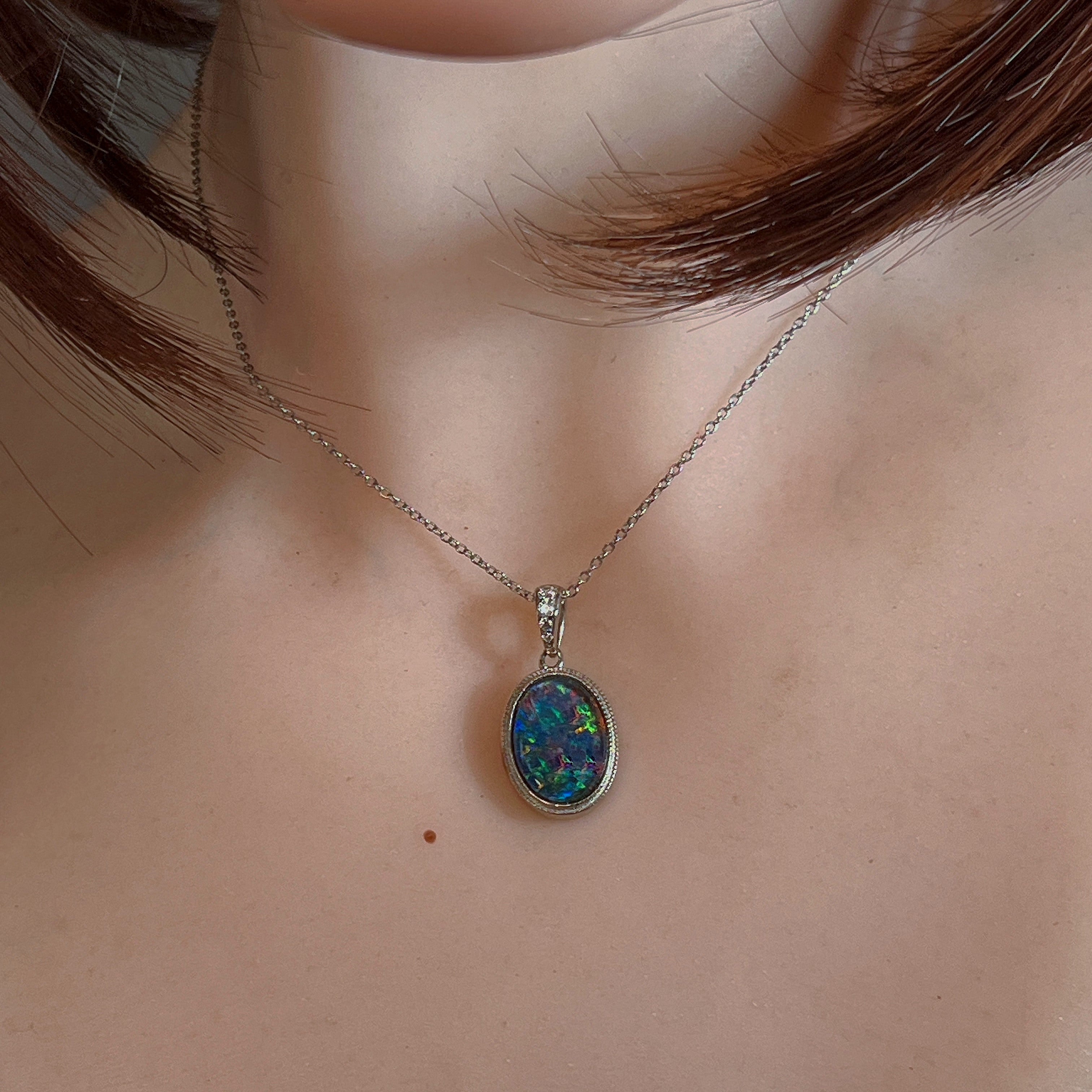 Oval opal triplet necklace in silver worn at the neck on a fine chain