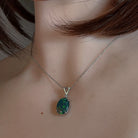 Oval opal triplet pendant in sterling silver worn on a fine chain at the neckline