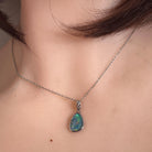Australian opal triplet pendant worn at the neck, blue, green and yellow play-of-colour