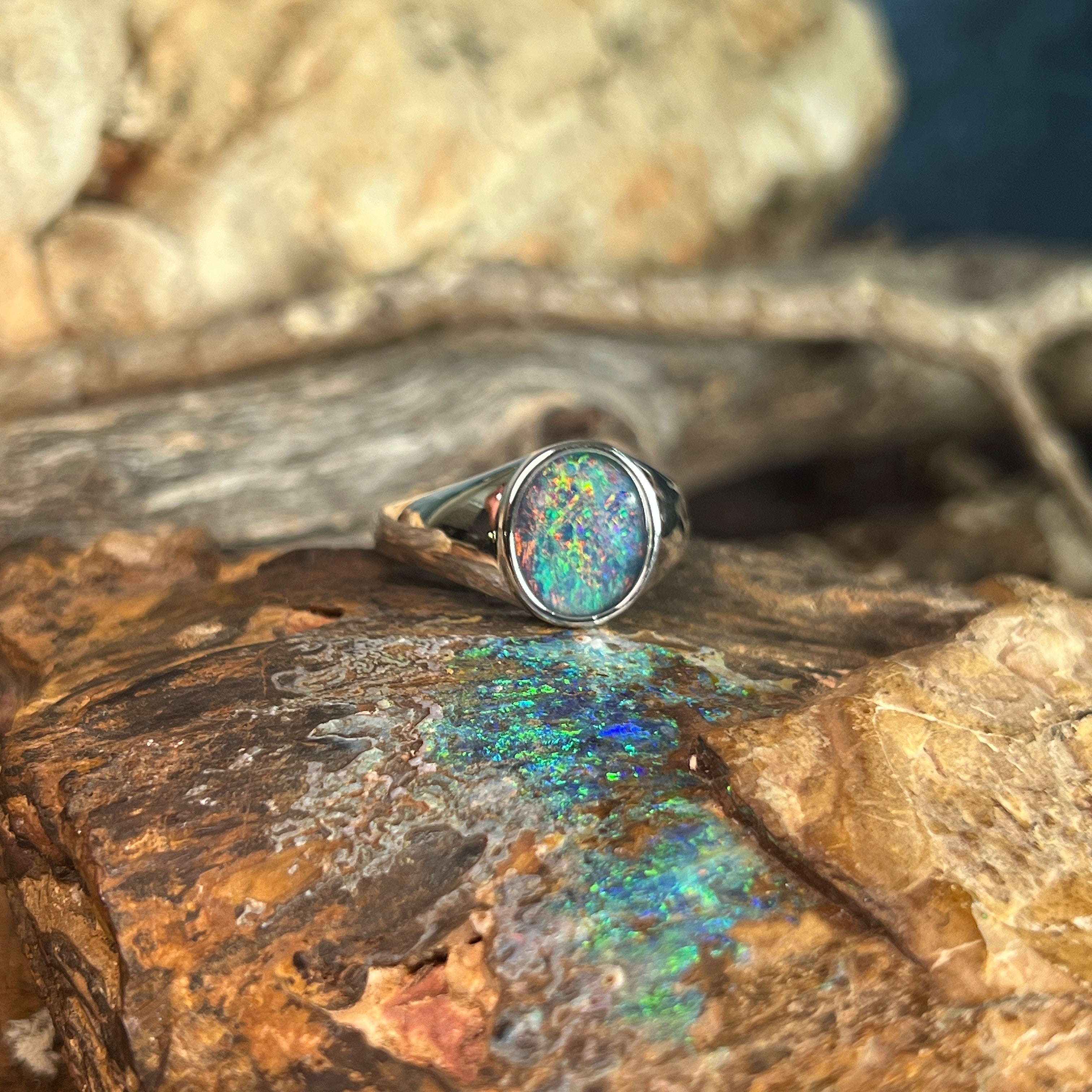 red, blue and green play-of-colour in a 12 x 10mm oval Australian opal triplet ring