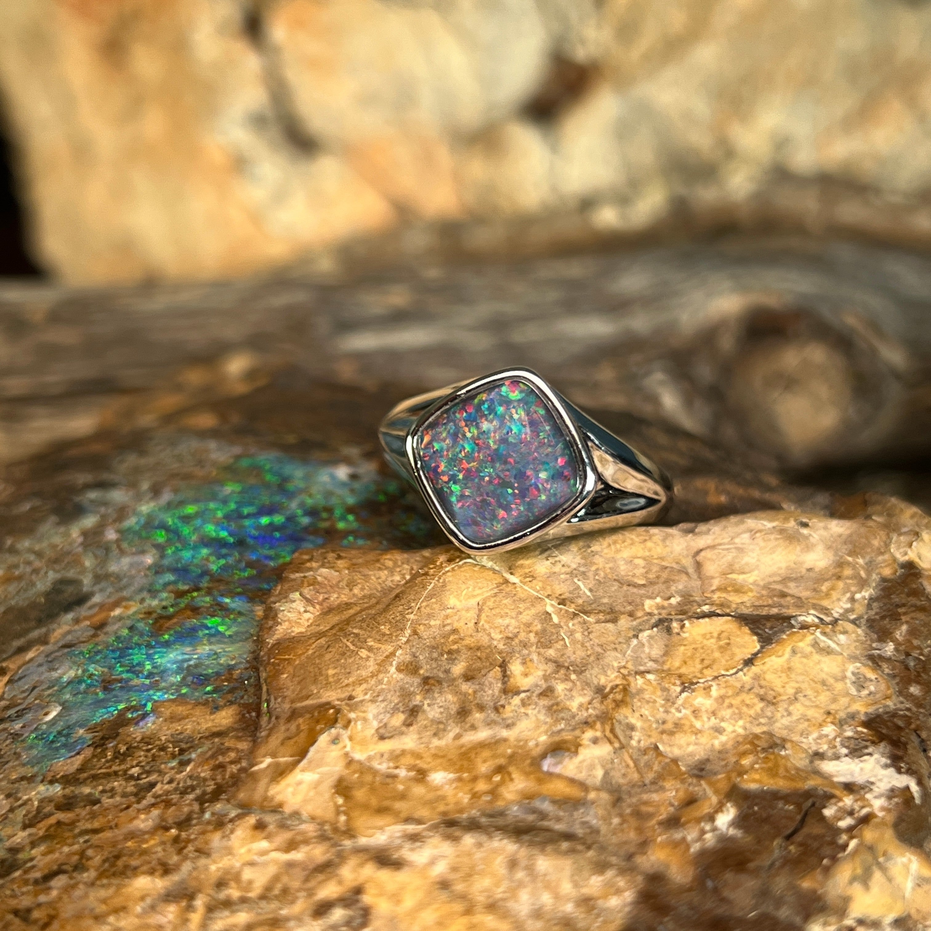 cushion-shaped Australian opal triplet ring in sterling silver, red, blue and green play-of-colour