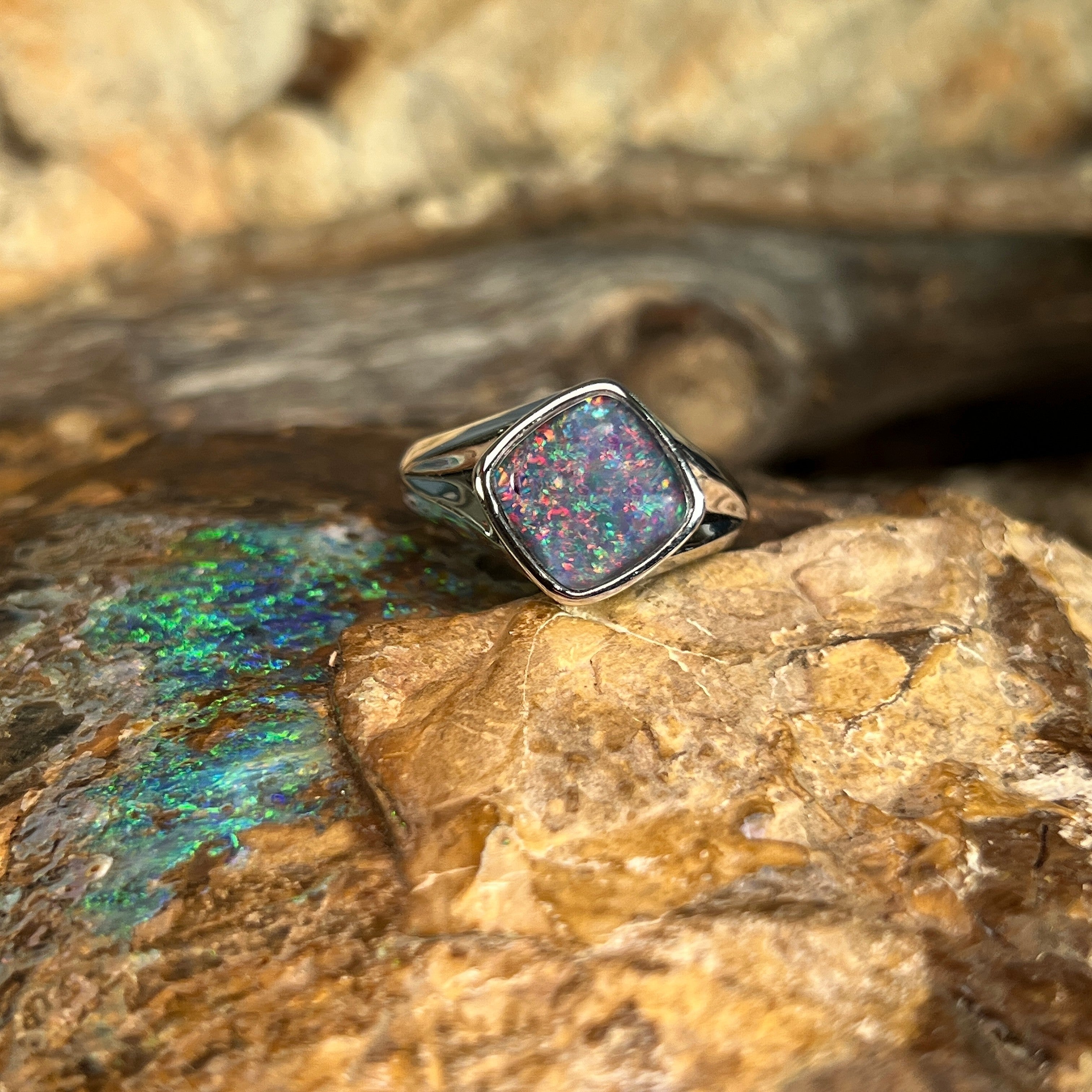 red, blue and green play-of-colour in a 10 x 10mm cushion-shaped Australian opal triplet ring