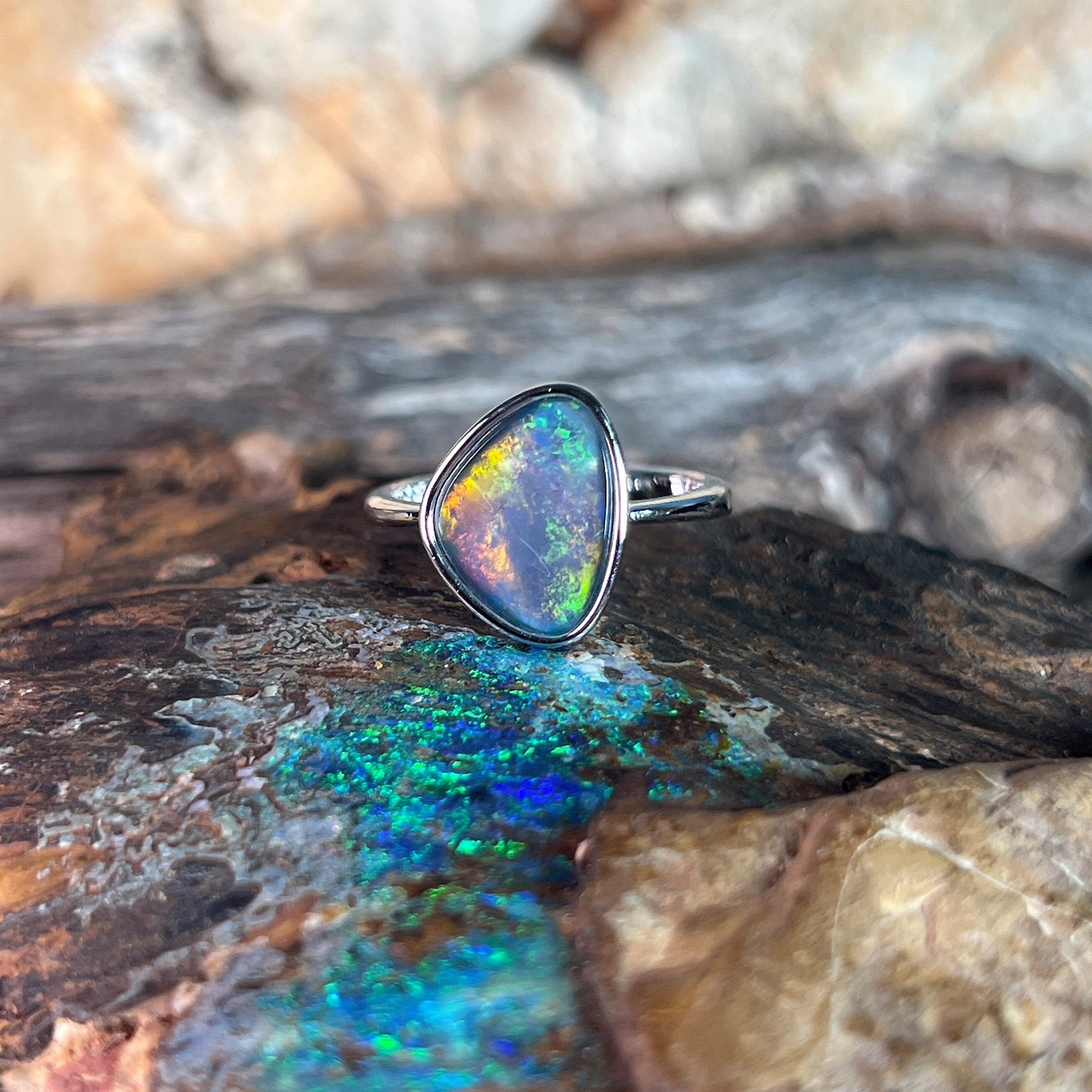 triangular Australian opal triplet ring in sterling silver, yellow, orange, blue and green play-of-colour