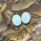 Pair of Australian white opals, 3.23ct for the two stones, side by side on ironstone