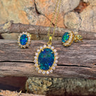 Gold-plated silver opal triplet halo pendant and matching studs on weathered driftwood