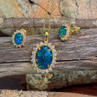 Close view of the 14x10mm opal triplet halo pendant and cluster studs in gold-plated silver