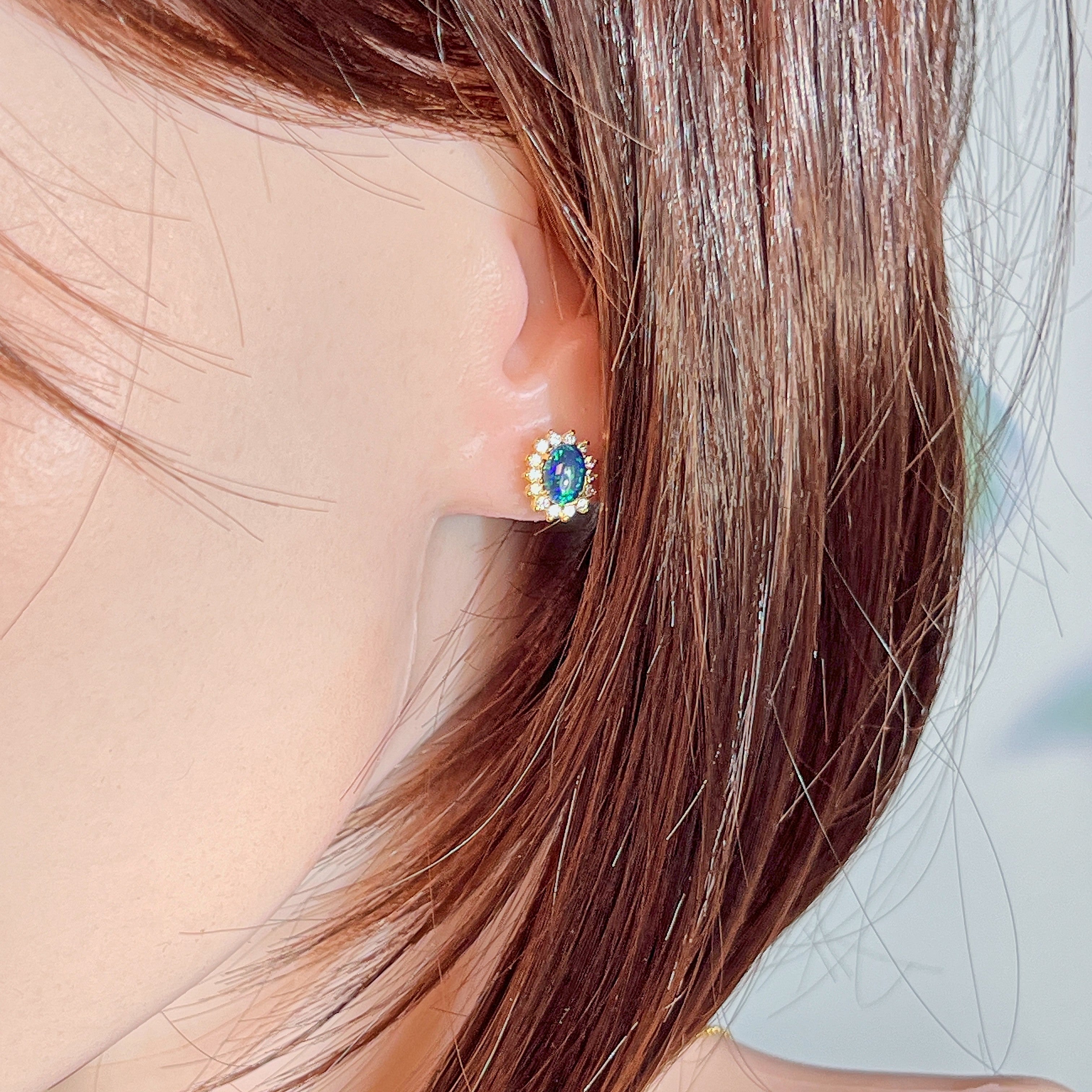 7x5mm opal triplet cluster earring worn on the ear beneath loose hair